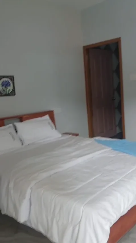 Portrait view of a bedroom inside the homestay.